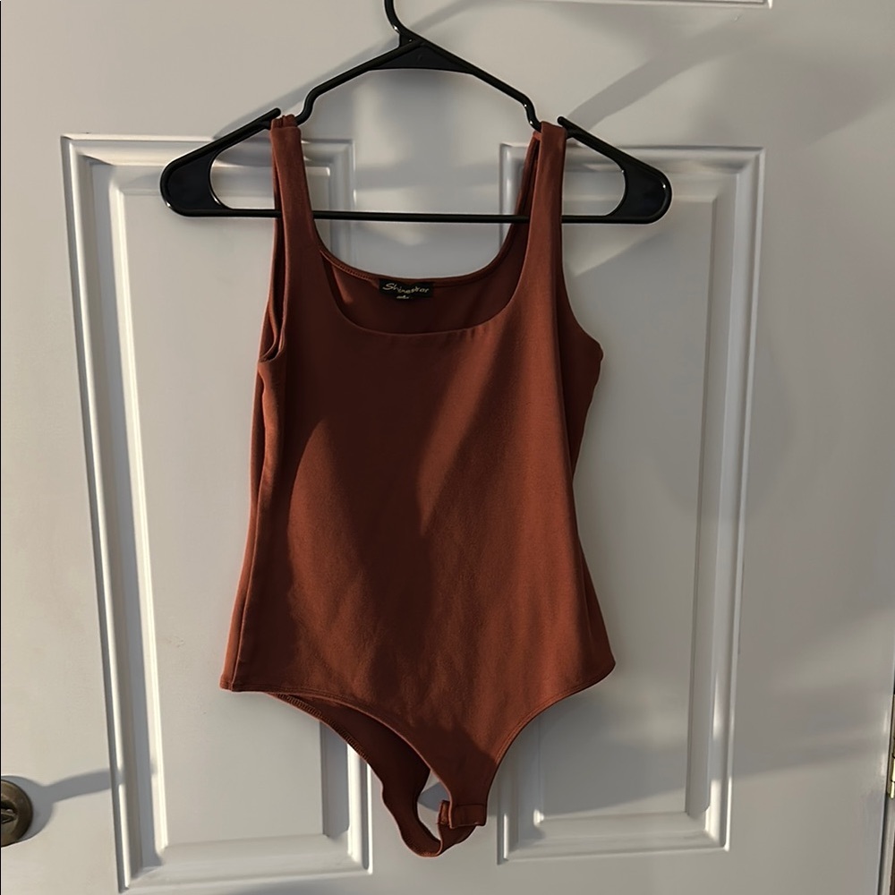 Shinestar Women’s brown bodysuit. Snap closure.